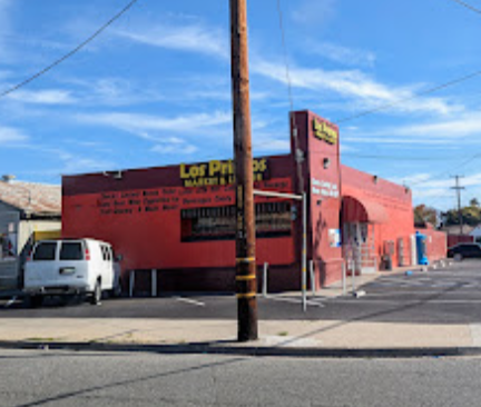Side view of the Los Primos Market building and parking area